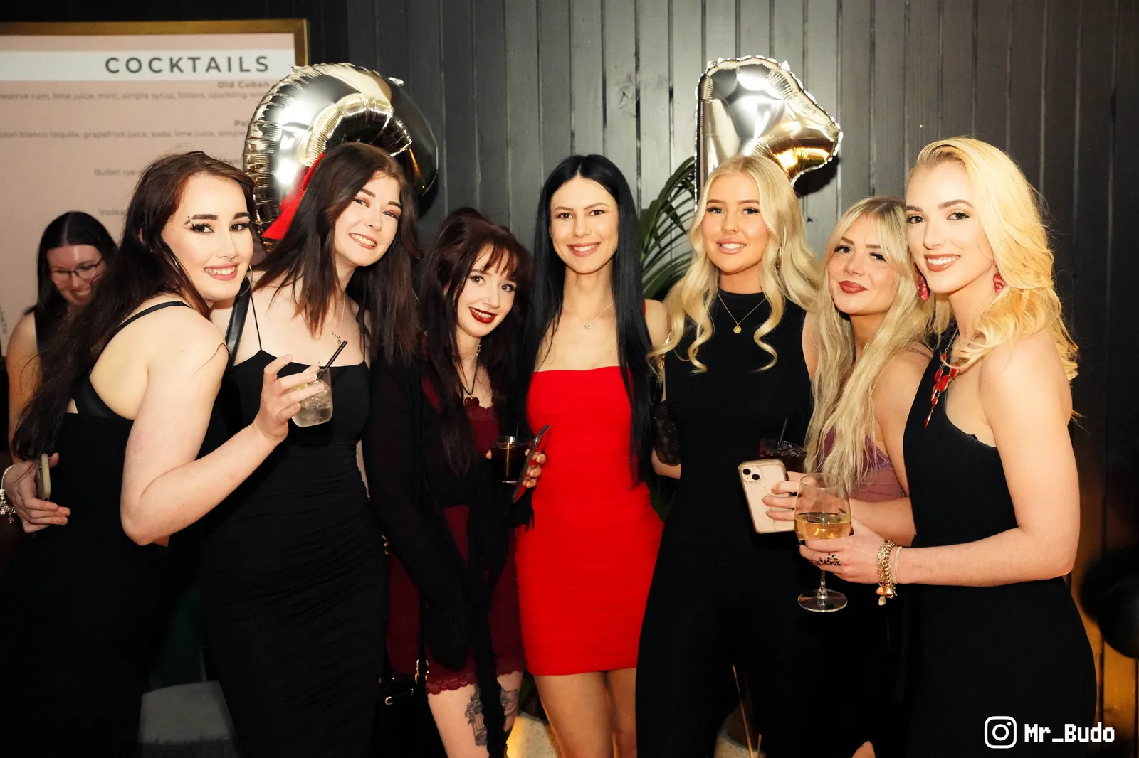 Group of women in cocktail dresses posing together at a birthday party in Canberra