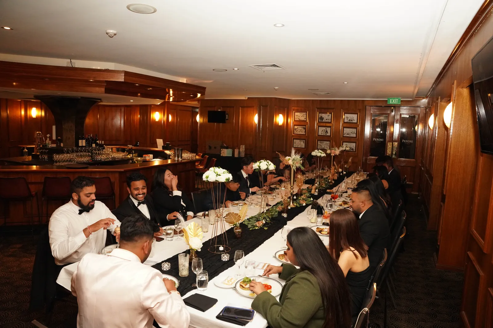 Guests seated along a long table at a formal Canberra lunch event